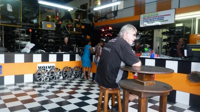 The SparesBoyz showroom interior, with alloy wheels and parts on the shelves