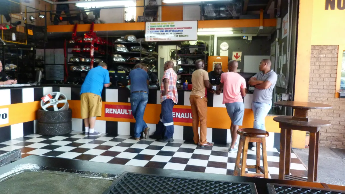 Customers being served along the SparesBoyz parts counter, under Renault signage