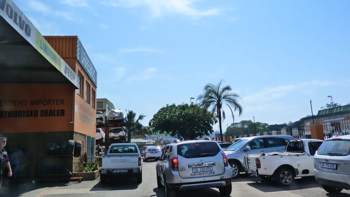 The SparesBoyz yard and building, with cars parked outside the shop